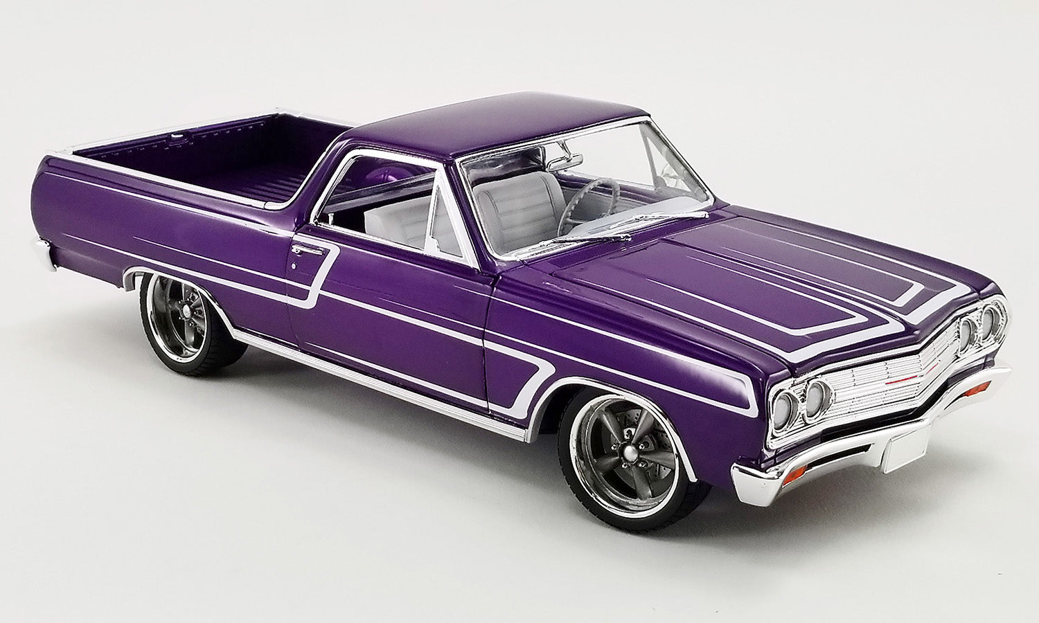 1/18 scale diecast model car of a purple Chevrolet El Camino.
