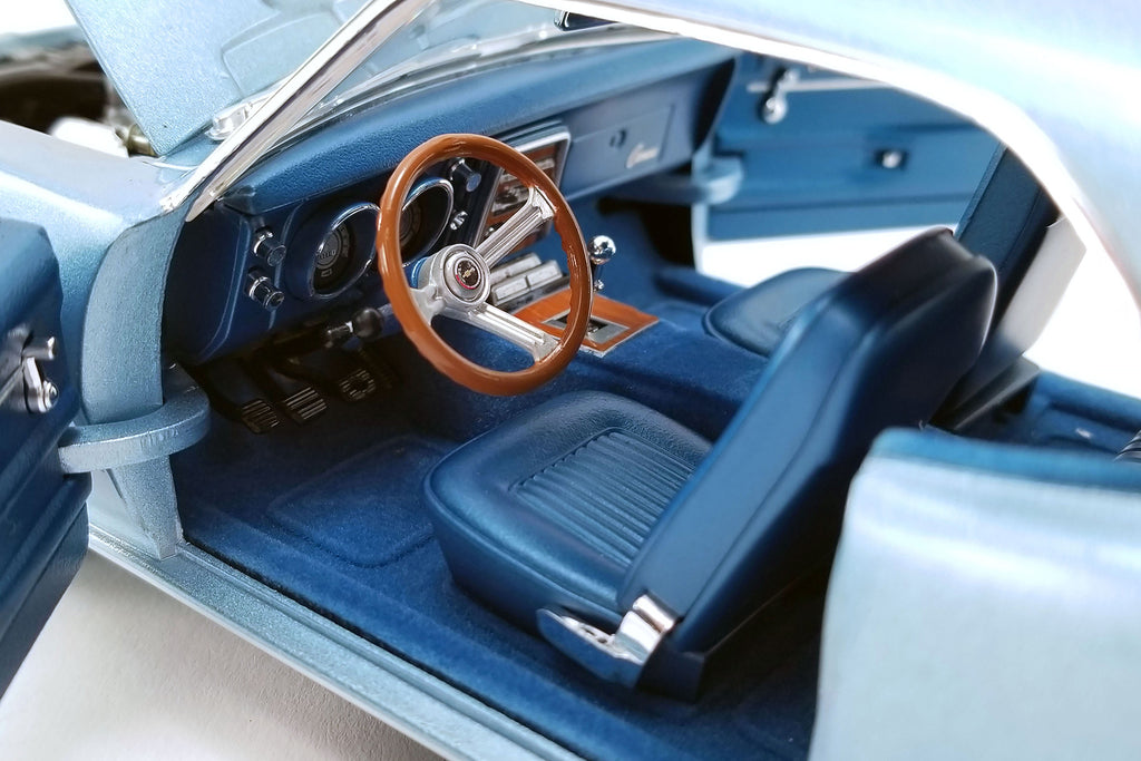 Close up of drivers side interior in a blue diecast model car.