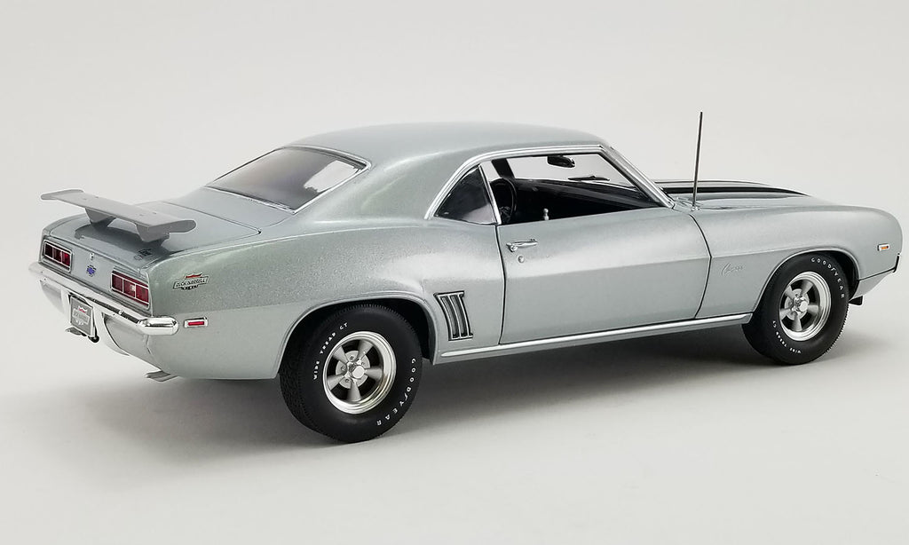 A 1/18 scale model of a 1969 Chevrolet COPO Camaro in silver color.