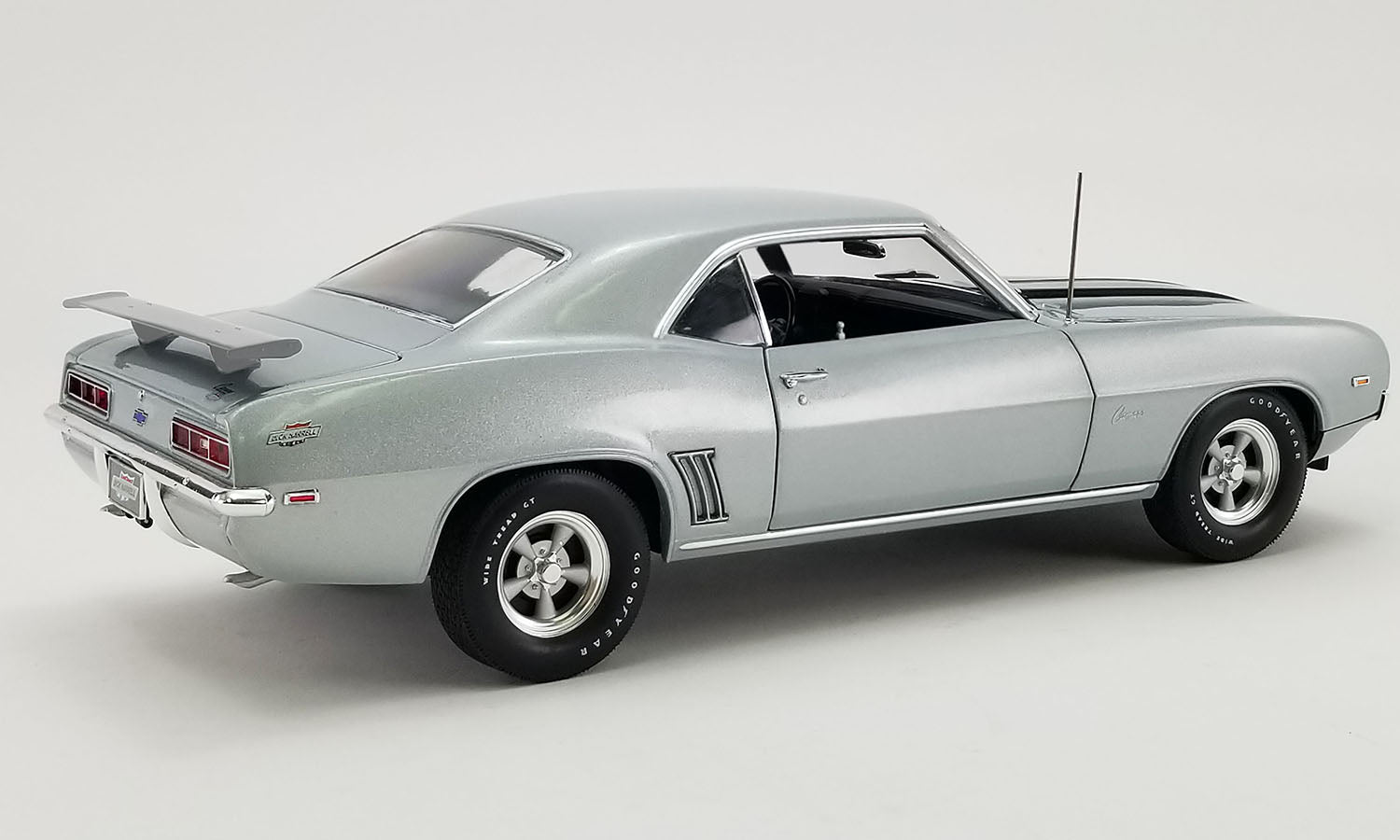 A 1/18 scale model of a 1969 Chevrolet COPO Camaro in silver color.