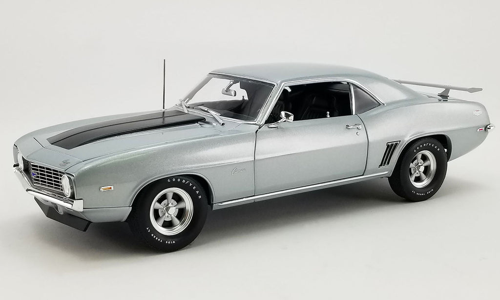 A 1/18 scale model of a 1969 Chevrolet COPO Camaro in silver color.