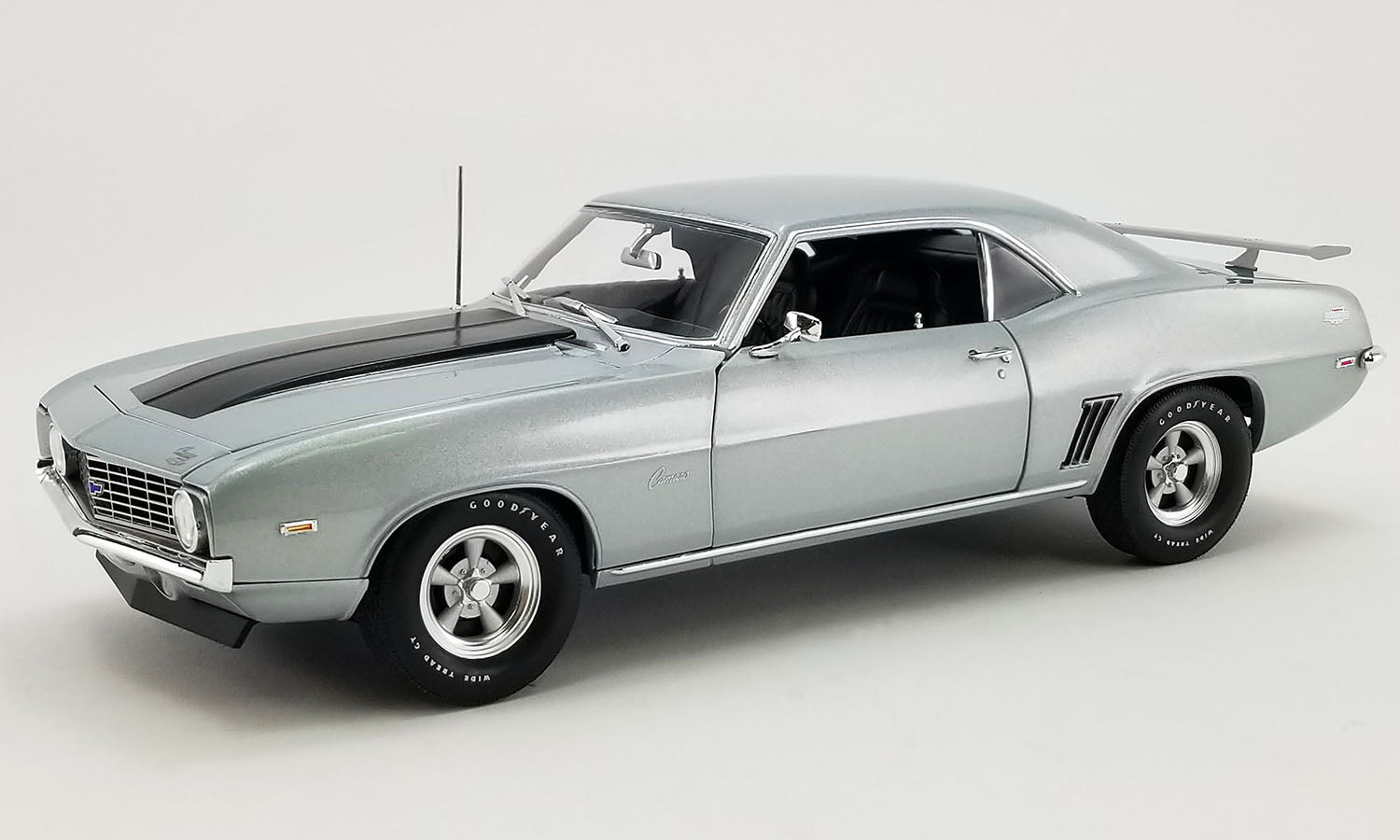 A 1/18 scale model of a 1969 Chevrolet COPO Camaro in silver color.