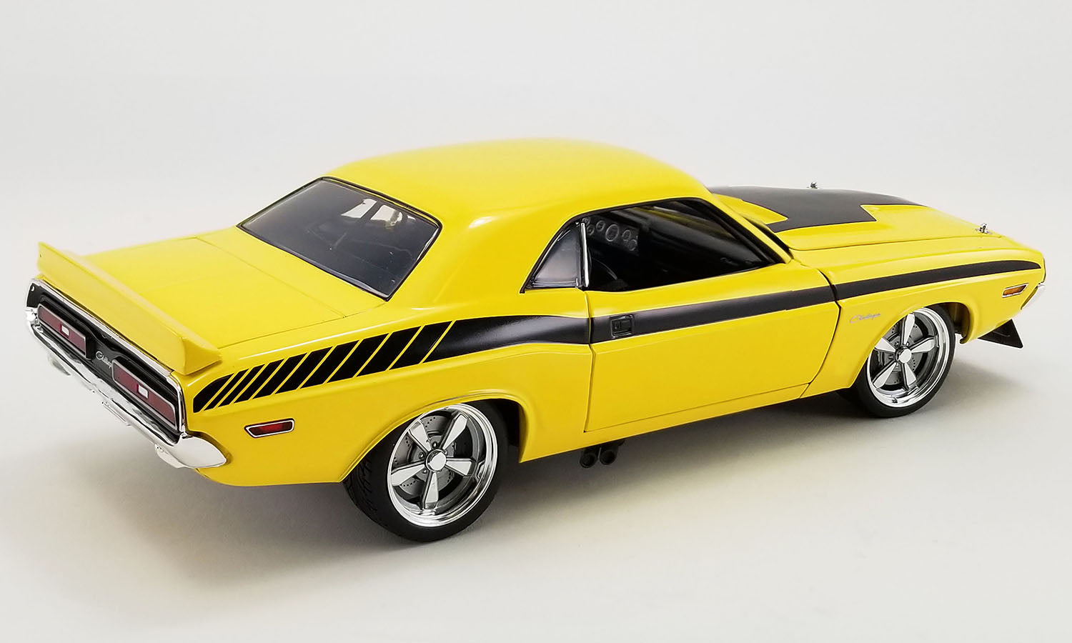 A 1/18 scale diecast model of a 1971 Dodge Challenger in a yellow and black color scheme.