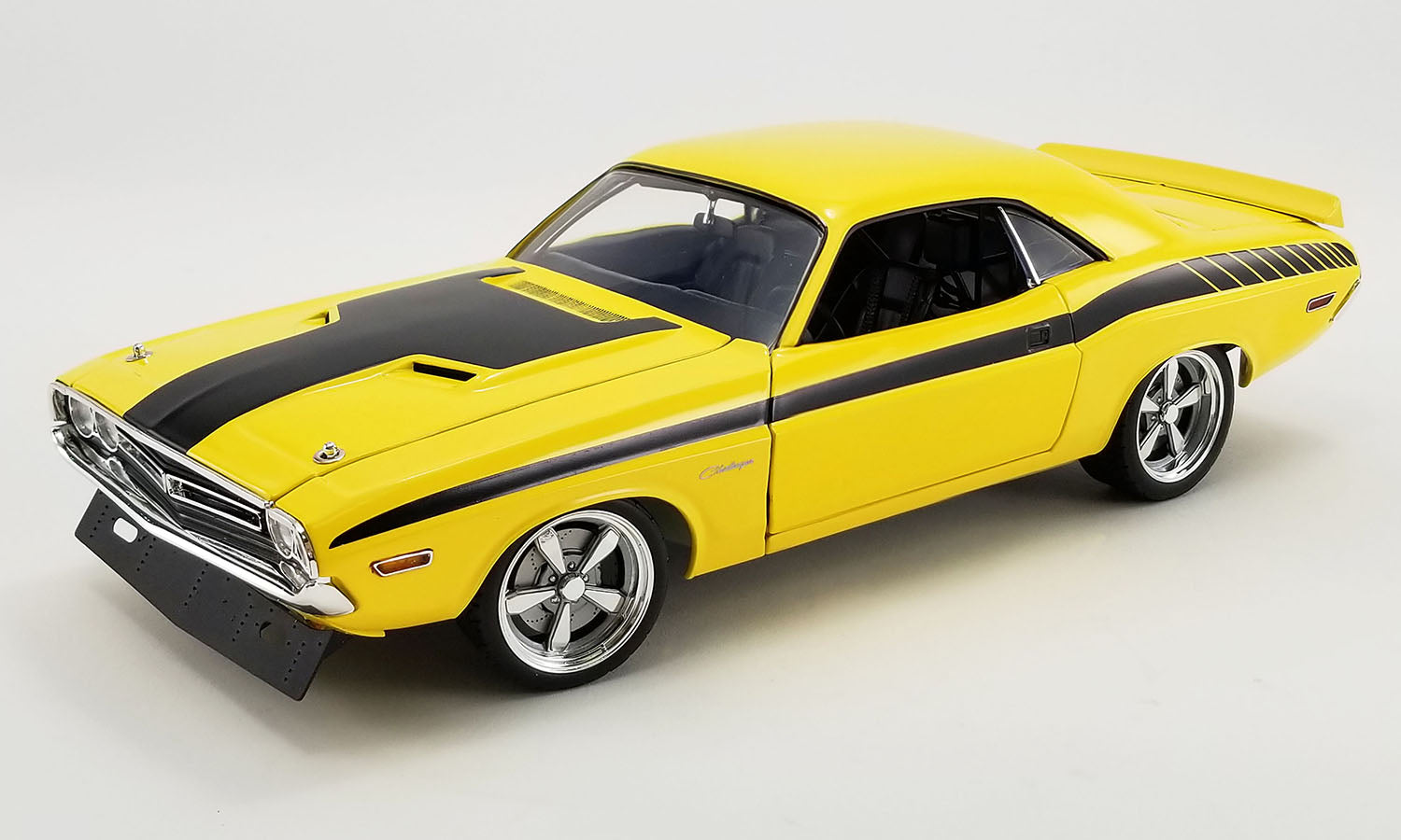 A 1/18 scale diecast model of a 1971 Dodge Challenger in a yellow and black color scheme.