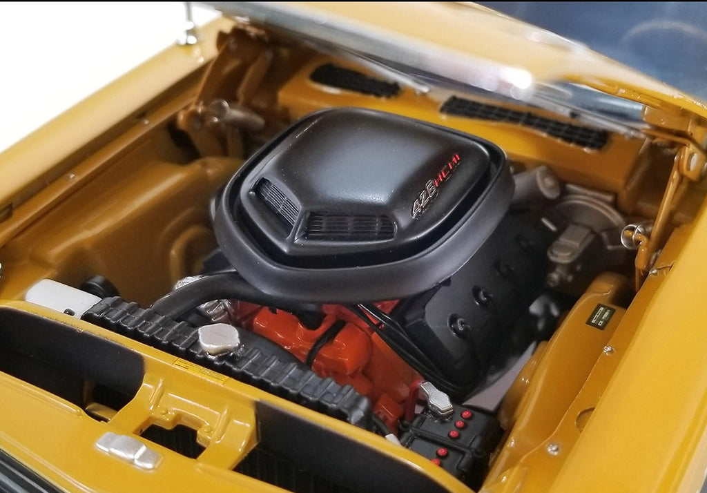 Detailed engine under the hood of a 1/18 scale diecast model car.