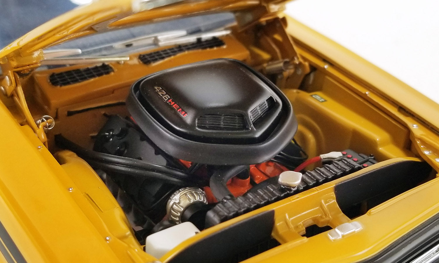 Under the hood of 1/18 scale diecast model car.