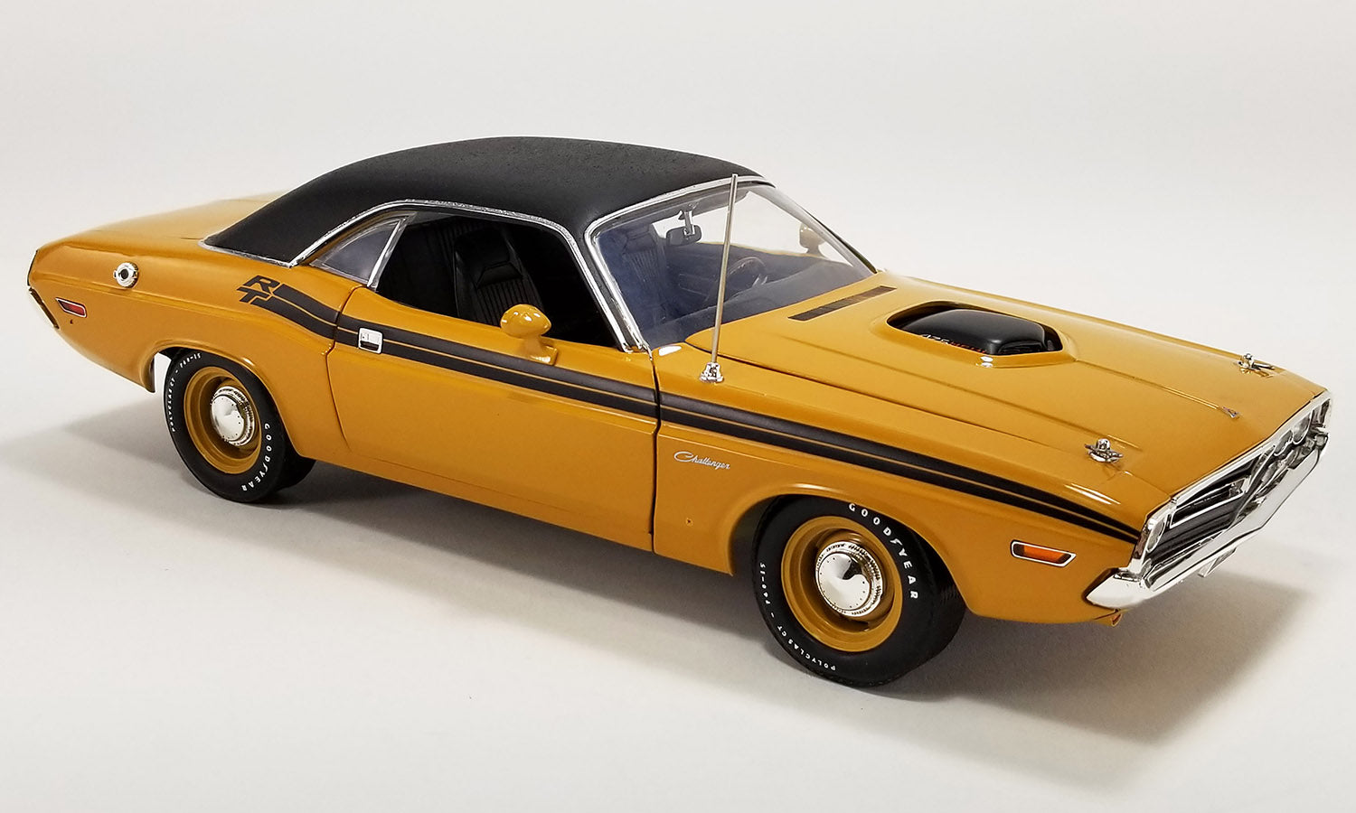 1/18 scale model of a 1971 Dodge Challenger R/T Hemi in butterscotch color with a black vinyl top.