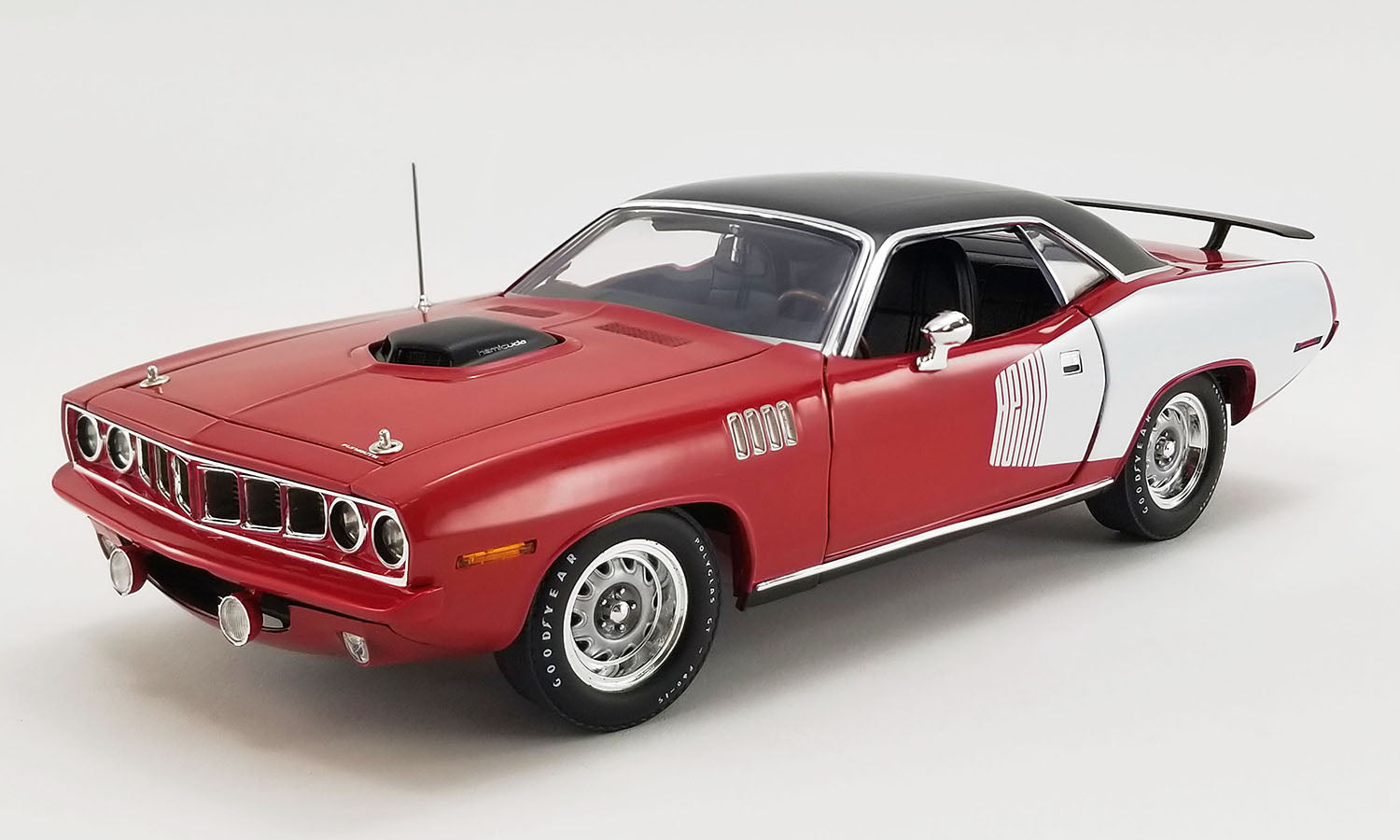 1/18 scale model of a red 1971 Plymouth Hemi Barracuda with white HEMI billboard and black roof.