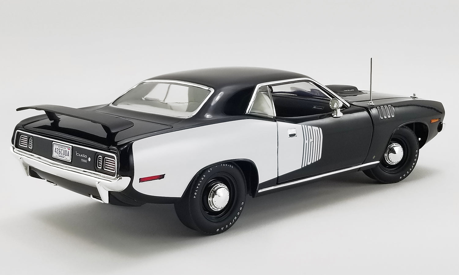 1/18 scale model car of 1971 Hemi Cuda in black with white.
