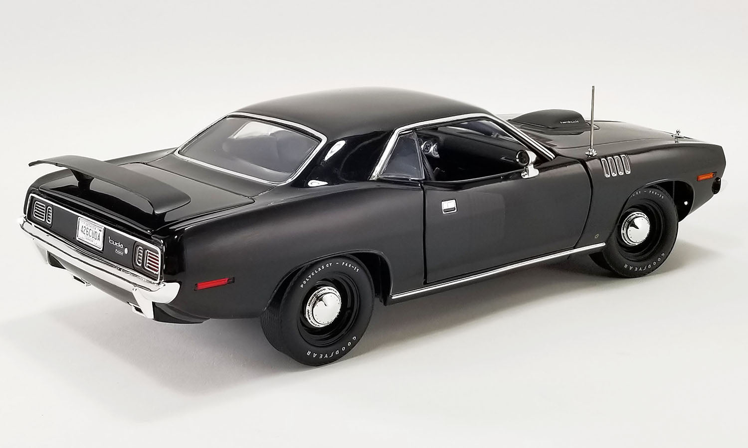 A 1/18 scale model of a 1971 Plymouth HEMI Barracuda in black.