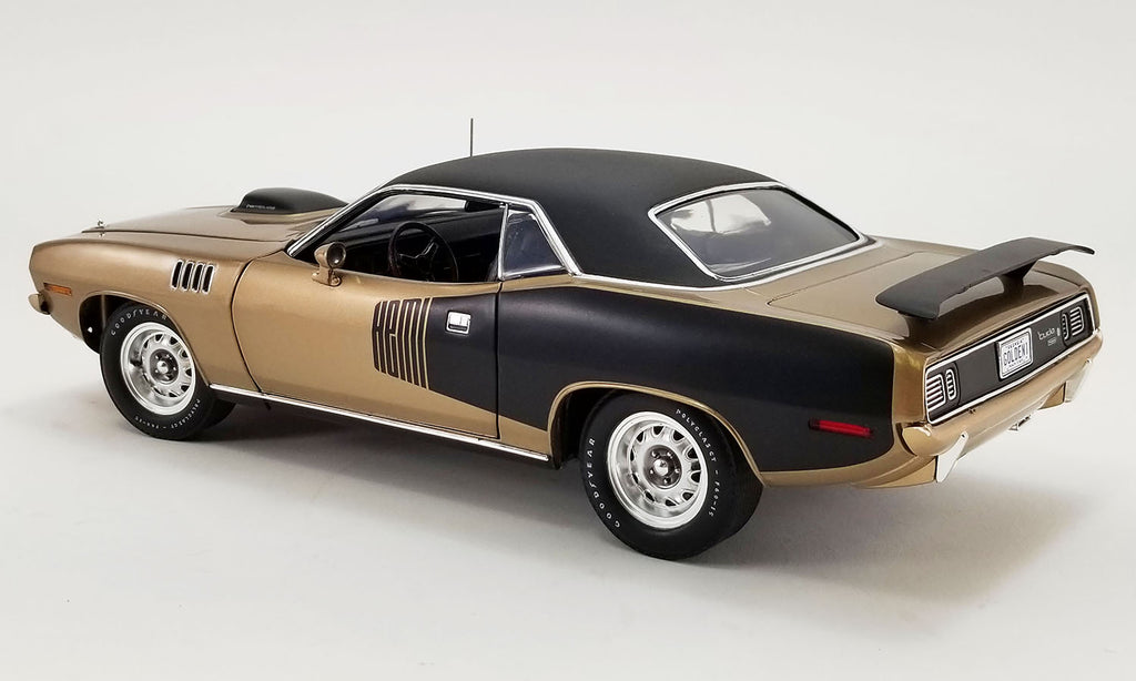 1/18 scale model of a 1971 Plymouth Hemi Barracuda in gold and black with a black vinyl top.