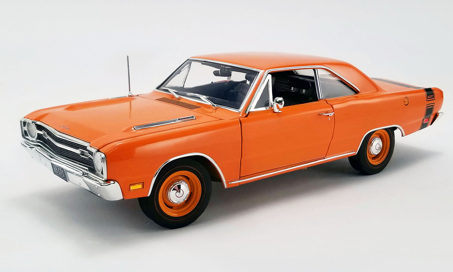 A 1/18 scale model of a 1969 Dodge Dart GTS in orange with black stripe on the rear.