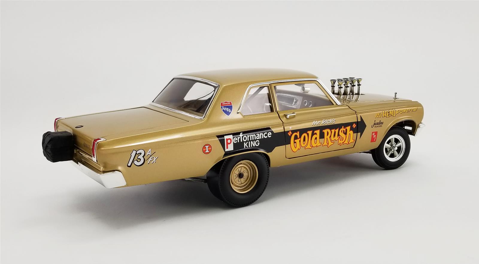 A 1/18 scale model of a 1965 Dodge AWB Coronet Gold Rush car in gold color with "Gold Rush" on the door.