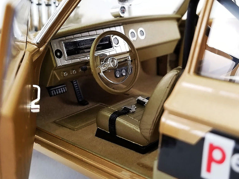 Close up of the interior on a diecast model car gold in color.