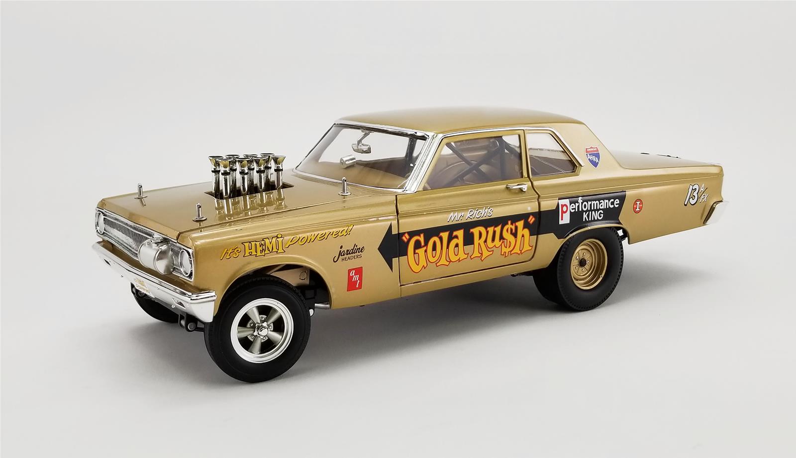 A 1/18 scale model of a 1965 Dodge AWB Coronet Gold Rush car in gold color with "Gold Rush" on the door.