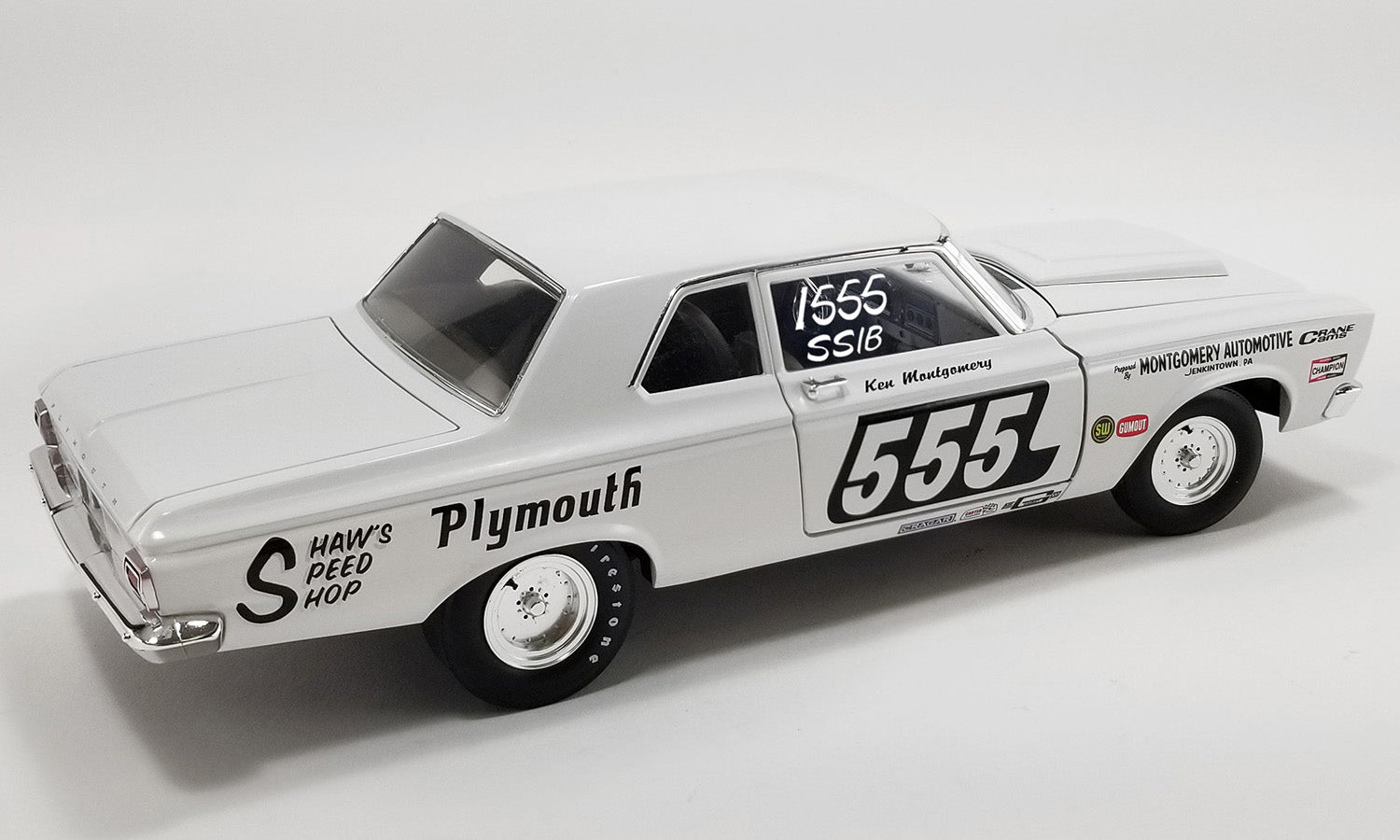 1/18 scale model of a 1965 Plymouth Belvedere Super Stock car with the number 555, 'Plymouth' text and other race decals on the side. 