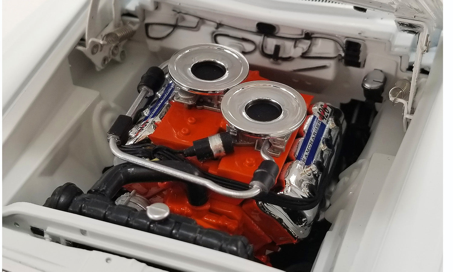 Under the hood view of the engine on a 1/18 scale model car.