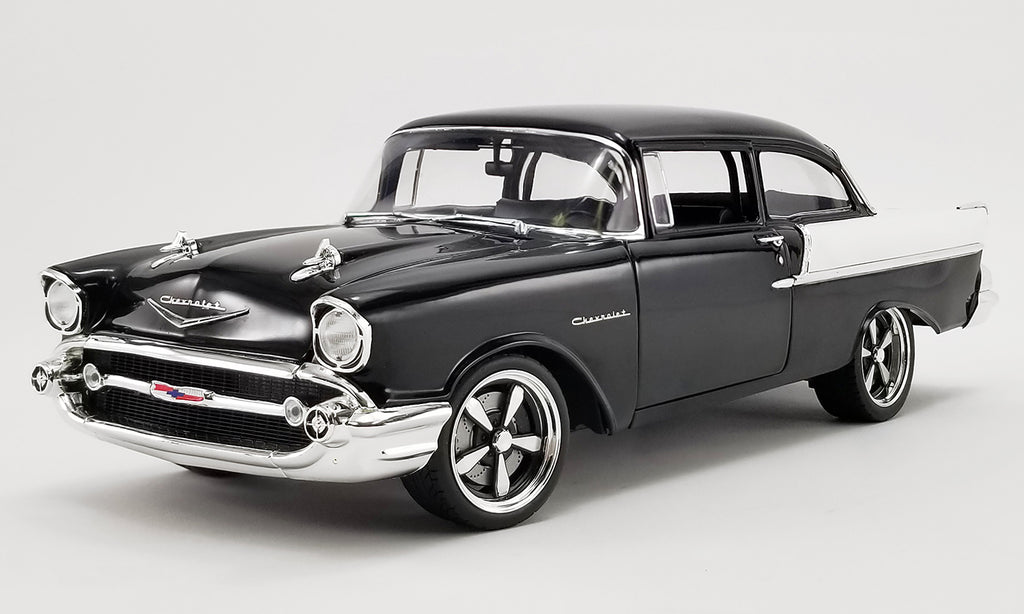 Diecast model car of a black 1957 Chevrolet 150.