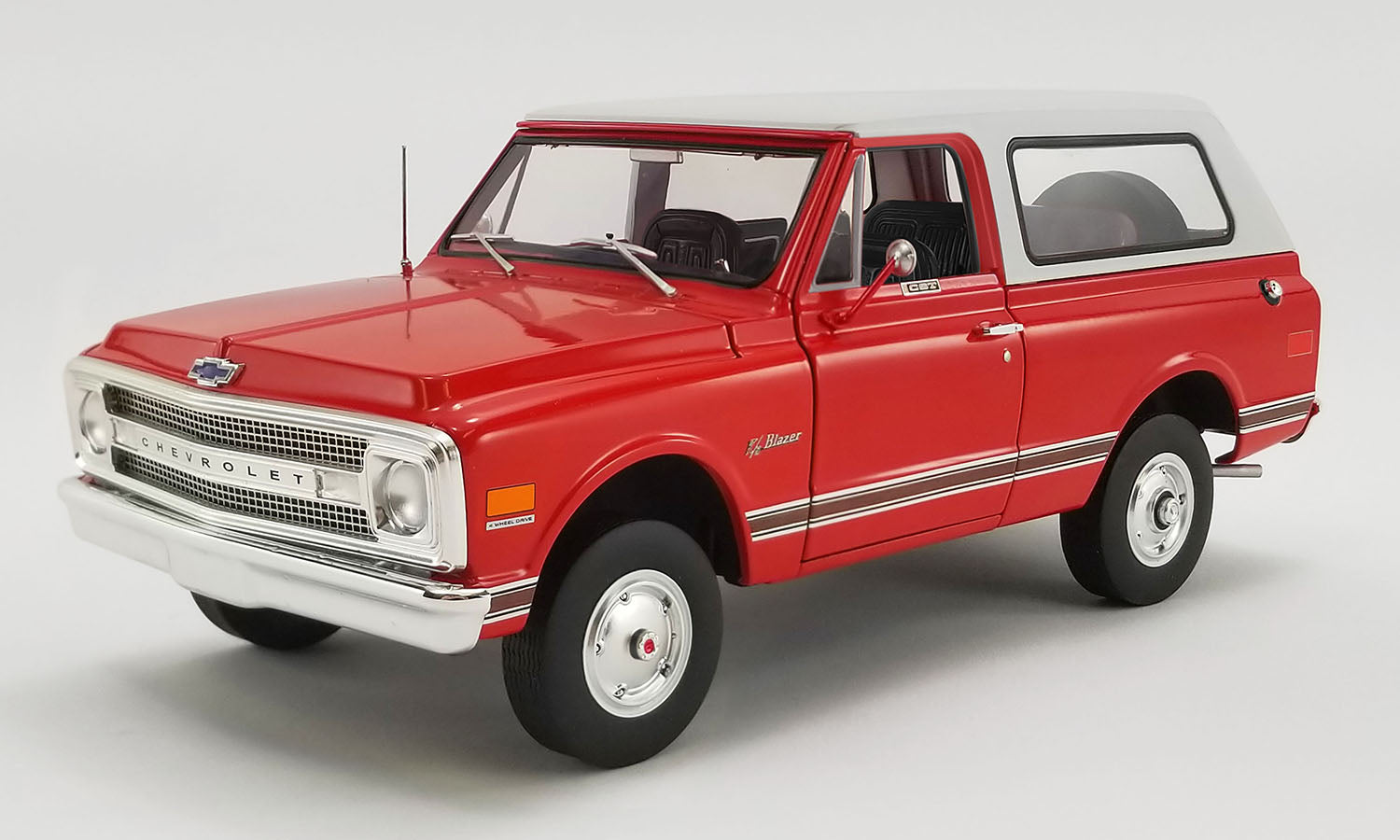 1/18 scale model of a red 1969 Chevrolet Blazer K/5 with white roof.