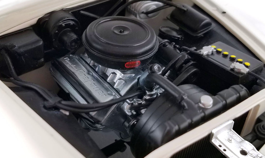 Under the hood of a 1/18 scale diecast model car.