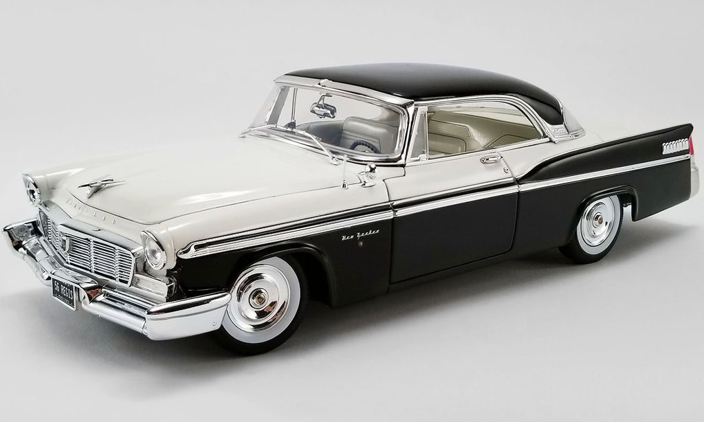 A 1/18 scale model of a 1956 Chrysler New Yorker St. Regis car painted in white and black.