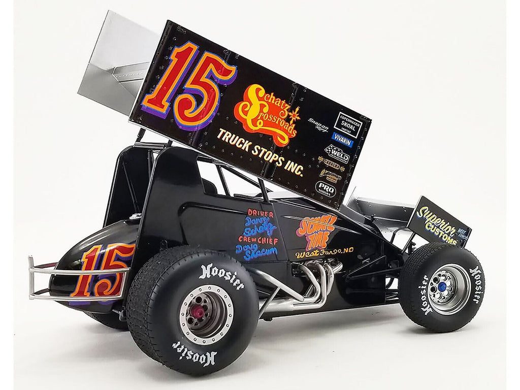Diecast model sprint car with "Schatz Crossroads" and the number 15 on the side.