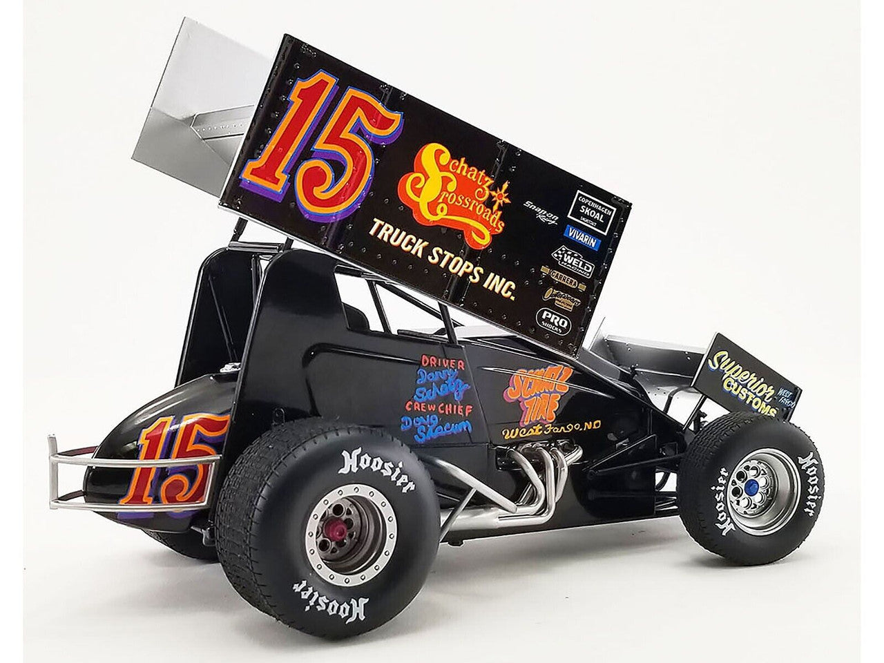 Diecast model sprint car with "Schatz Crossroads" and the number 15 on the side.