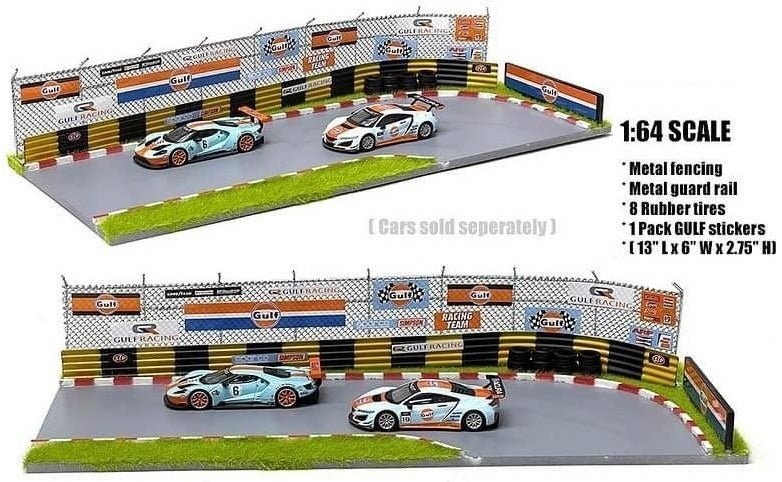 Race Diorama of corner of track with metal fencing and guard rails and Gulf branded signs