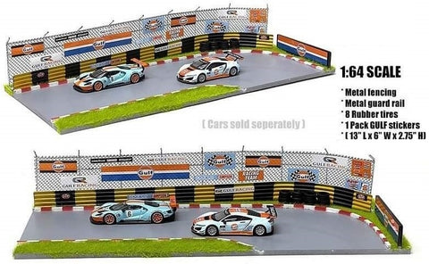 Race Diorama of corner of track with metal fencing and guard rails and Gulf branded signs