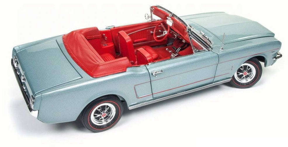 A 1/18 scale model of a 1965 Ford Mustang Convertible in gray with a red interior.