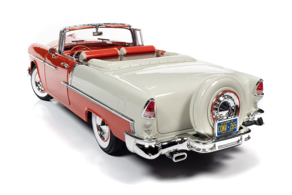 A 1/18 scale model of a 1955 Chevy Bel Air Convertible in red and ivory colors with open convertible top.