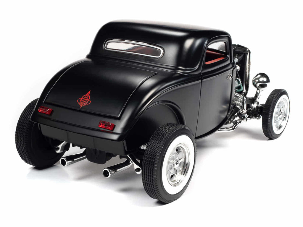 A 1/18 scale model of a 1934 Ford 3 Window Coupe with a black body, real rubber tires, and an open hood showing a detailed engine compartment.