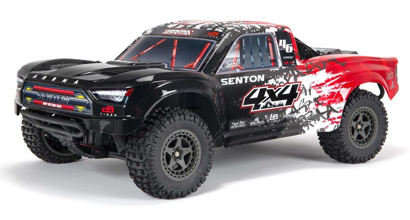 Side view of black and red short course truck with lexan body.