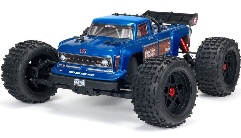 Front and side view of blue stunt truck with wide wheel base.