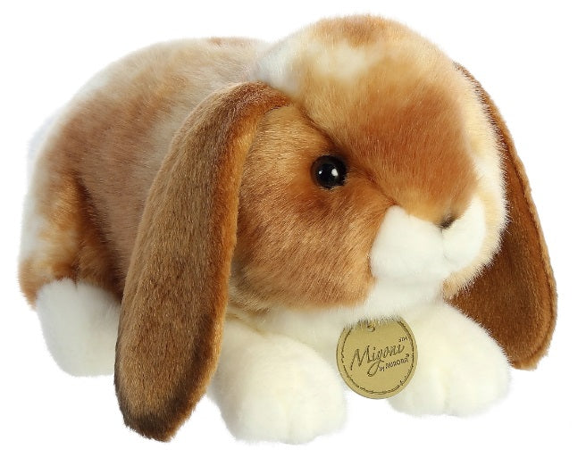 A plush toy resembling a Holland Lop rabbit with a caramel-tan and white body and big floppy ears.