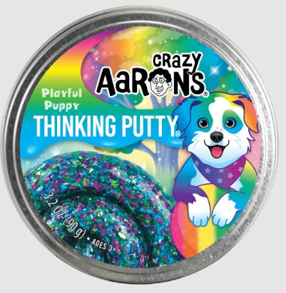 Round metal tin with picture of a colorful puppy and a swirl of green, purple, and blue putty.