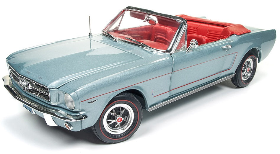 A 1/18 scale model of a 1965 Ford Mustang Convertible in gray with a red interior.