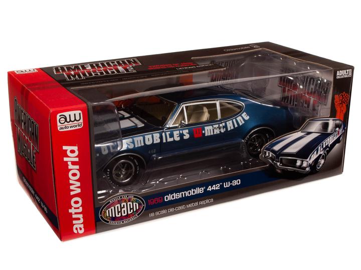 A 1/18 scale diecast model of a 1969 Oldsmobile Cutlass 442 in blue with white stripes and the text 'Dr. Oldsmobile's Machine' on the side in a box with a display window.