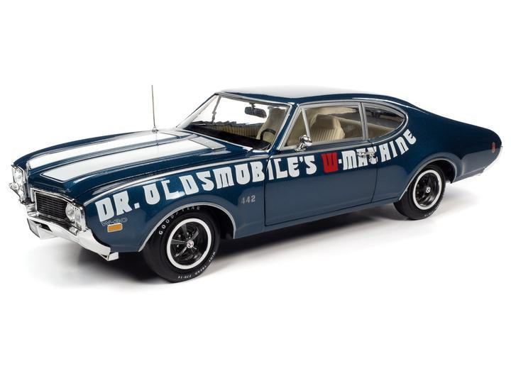 A 1/18 scale diecast model of a 1969 Oldsmobile Cutlass 442 in blue with white stripes and the text 'Dr. Oldsmobile's Machine' on the side.