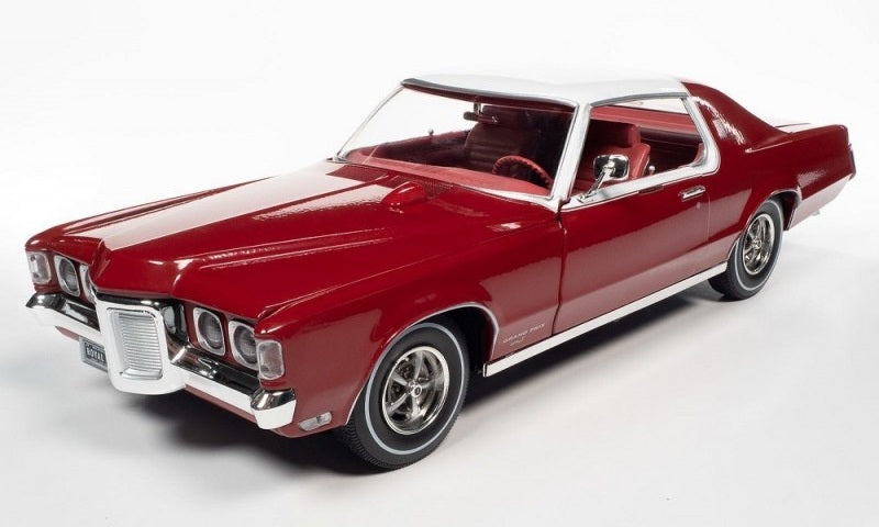 A 1/18 scale model of a 1969 Pontiac Grand Prix Royal Bobcat in red color with white roof.