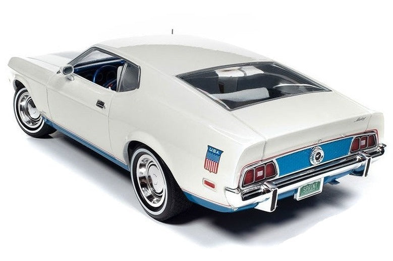 A 1/18 scale model of a 1972 Ford Mustang Fastback in white with blue stripes.