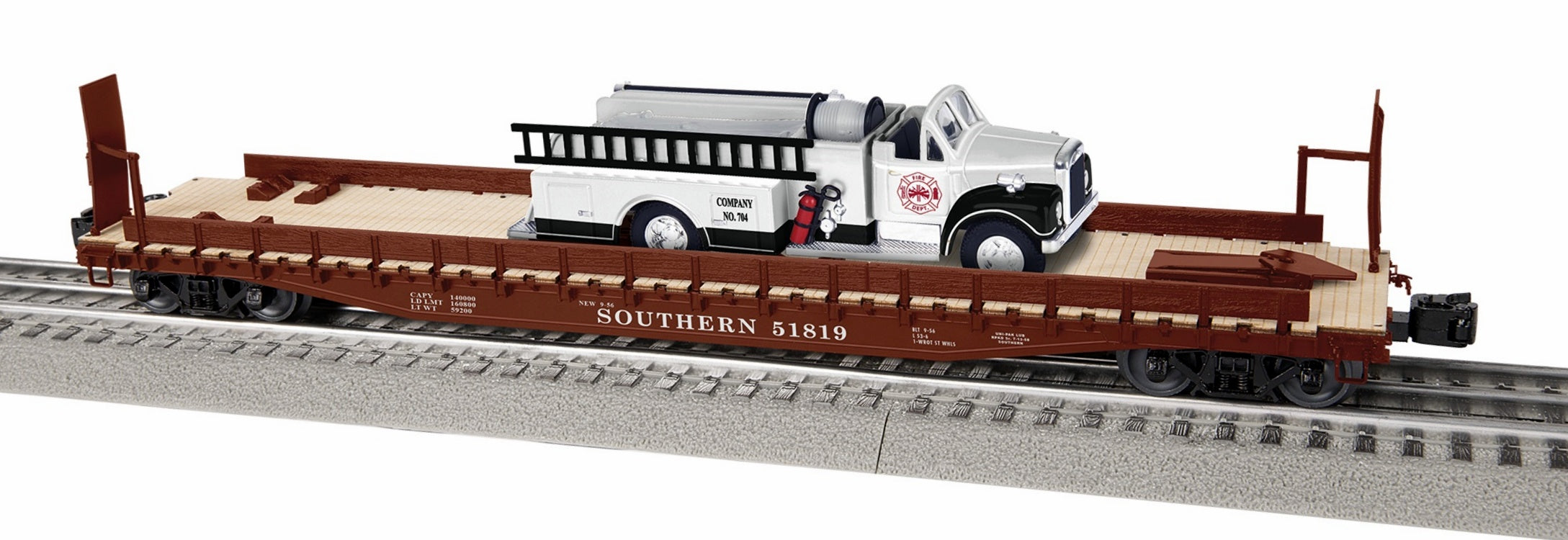 Lionel brand model of a firetruck on a flat car.