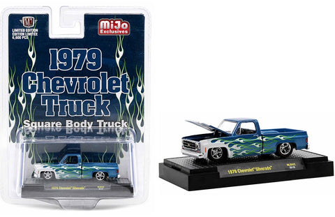 Model of a 1979 Chevrolet Silverado in blue with white and green flames on a display base and in a clam shell package.