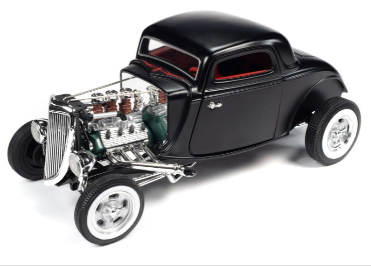 A 1/18 scale model of a 1934 Ford 3 Window Coupe with a black body, real rubber tires, and an open hood showing a detailed engine compartment.