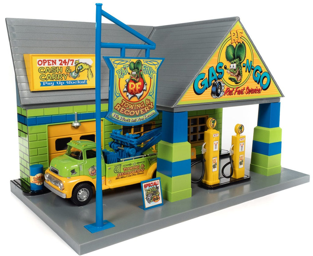 A 1/48 scale model of the Rat Fink Garage with a tow truck set. The garage and tow truck are painted in matching bright colors with Rat Fink graphics.