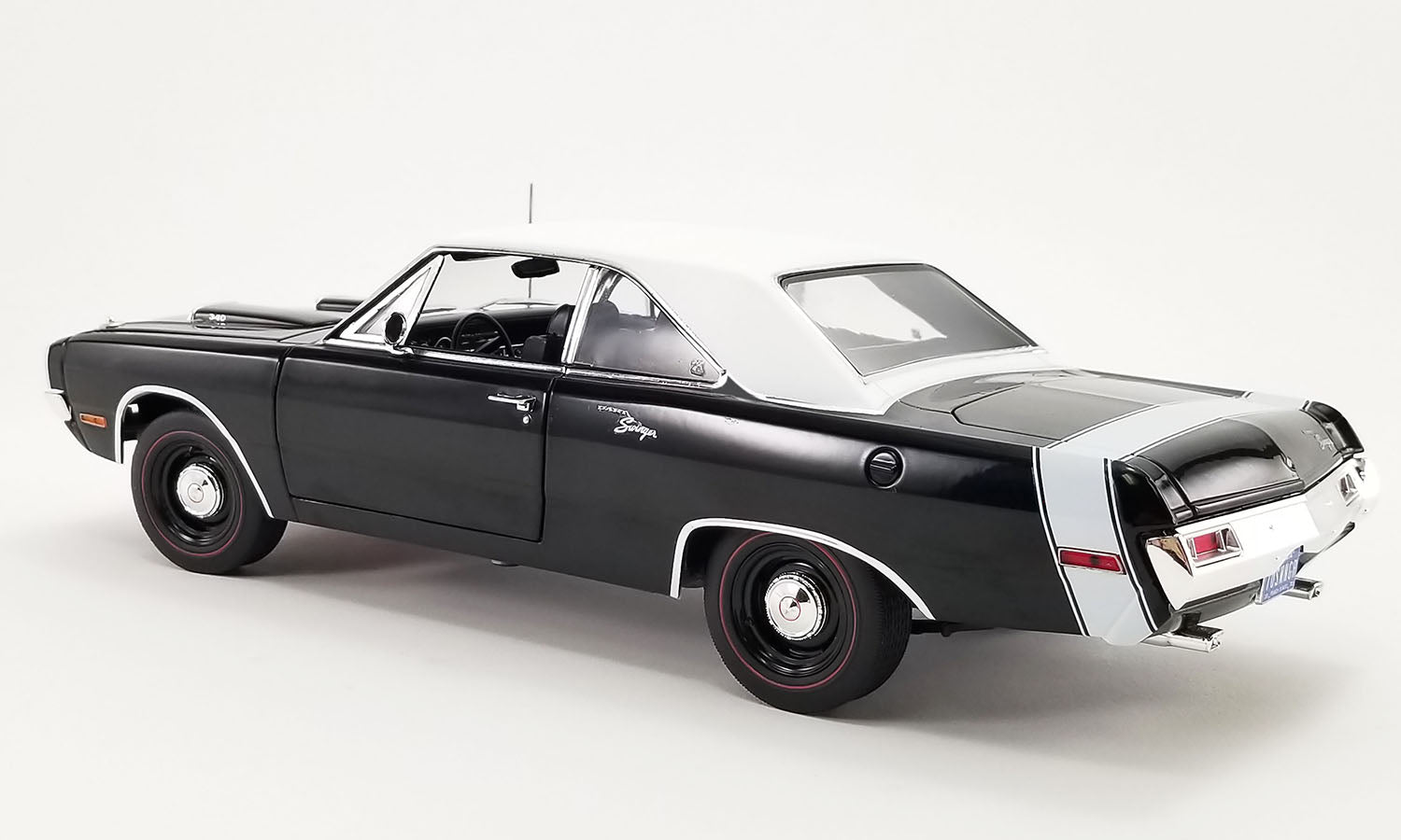 1/18 scale diecast car of a 1970 Dodge Dart Swinger 340 with a white tail stripe and white vinyl top, view of rear drivers side