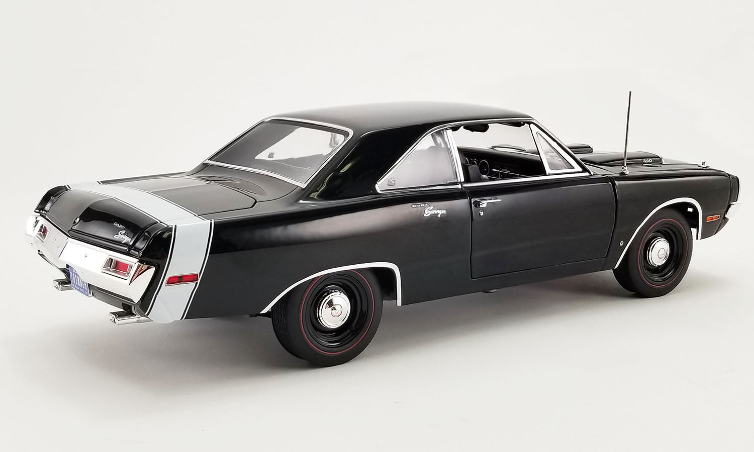 1/18 scale diecast car of a 1970 Dodge Dart Swinger 340 with a white tail stripe, view of rear passenger side