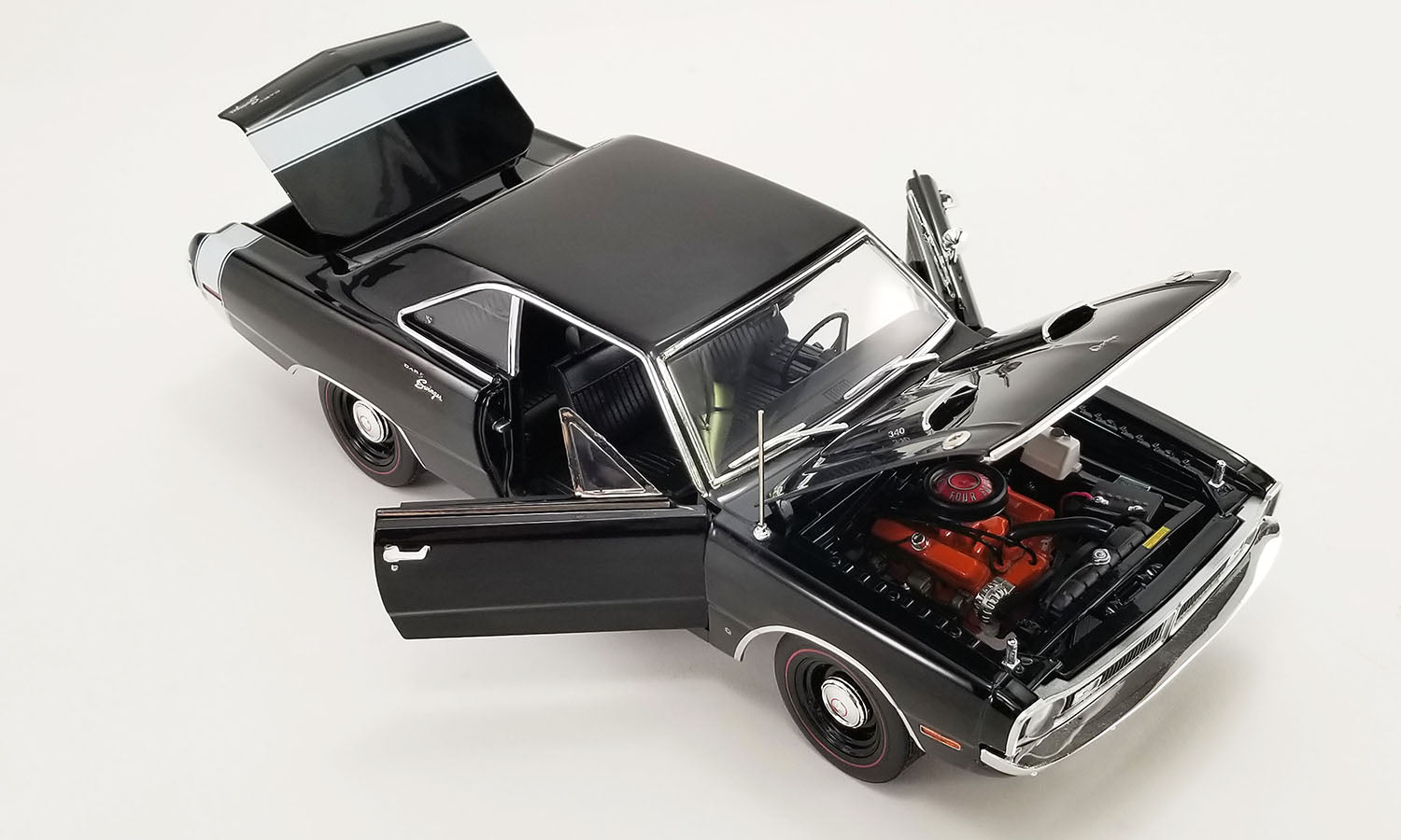 1/18 scale diecast car of a 1970 Dodge Dart Swinger 340 with a white tail stripe showing opening passenger and drivers side doors, trunk and hood.