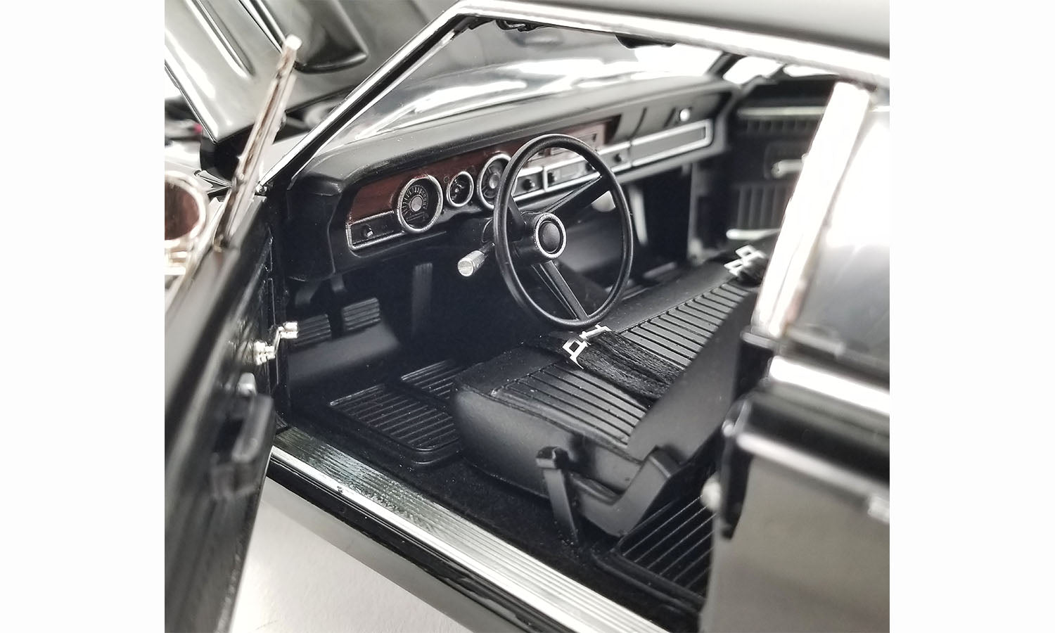 Interior view of drivers side of 1/18 scale diecast car of a 1970 Dodge Dart Swinger 340 with a white tail stripe
